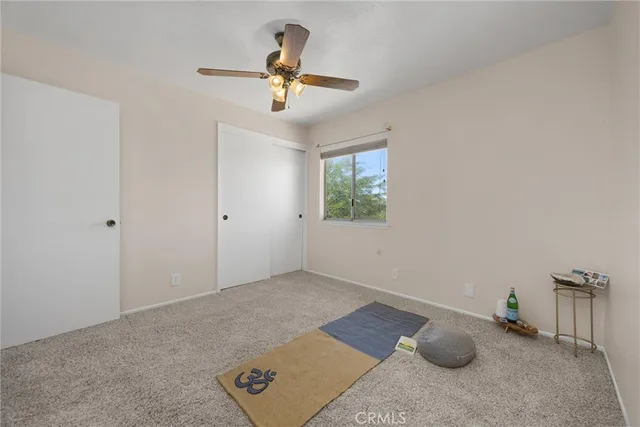 a view of livingroom with workspace and a window
