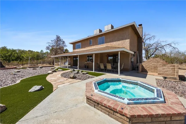 a view of a house with swimming pool and sitting area