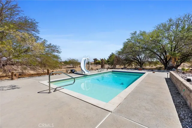 a view of swimming pool with a yard