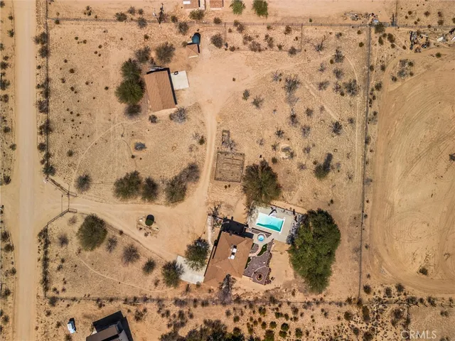 an aerial view of a house with a yard and lake view