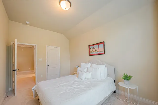 a bedroom with a bed and a chair