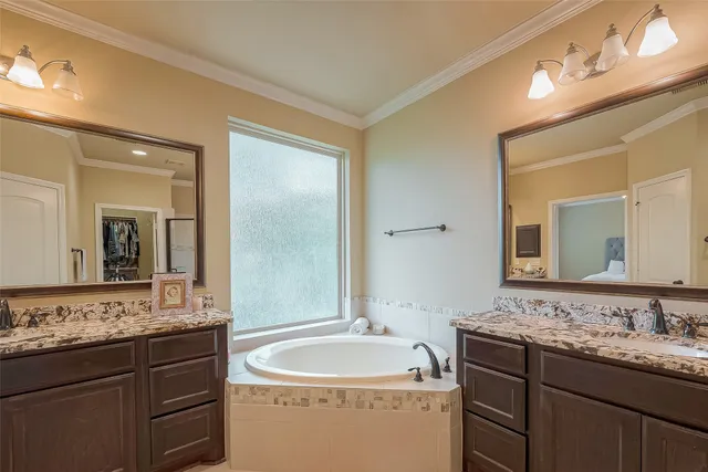 a bathroom with a granite countertop sink double and mirror