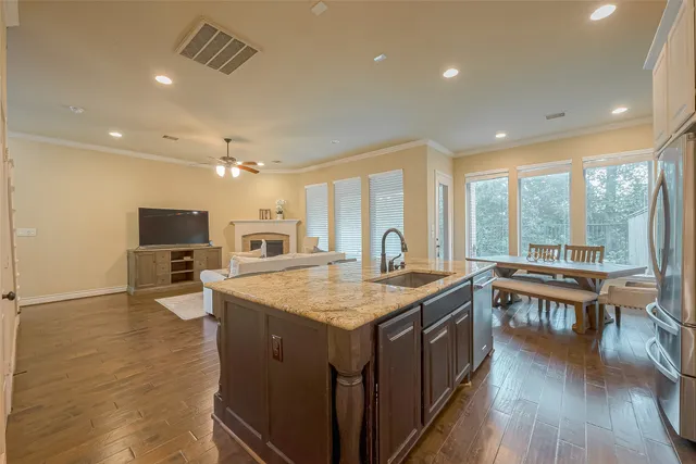 a kitchen with sink stove and refrigerator