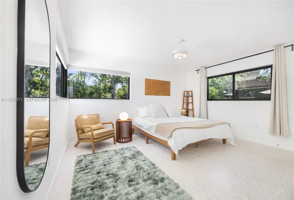 a living room with a bed furniture and a window