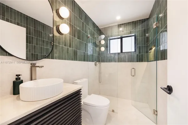 a bathroom with a sink toilet and shower