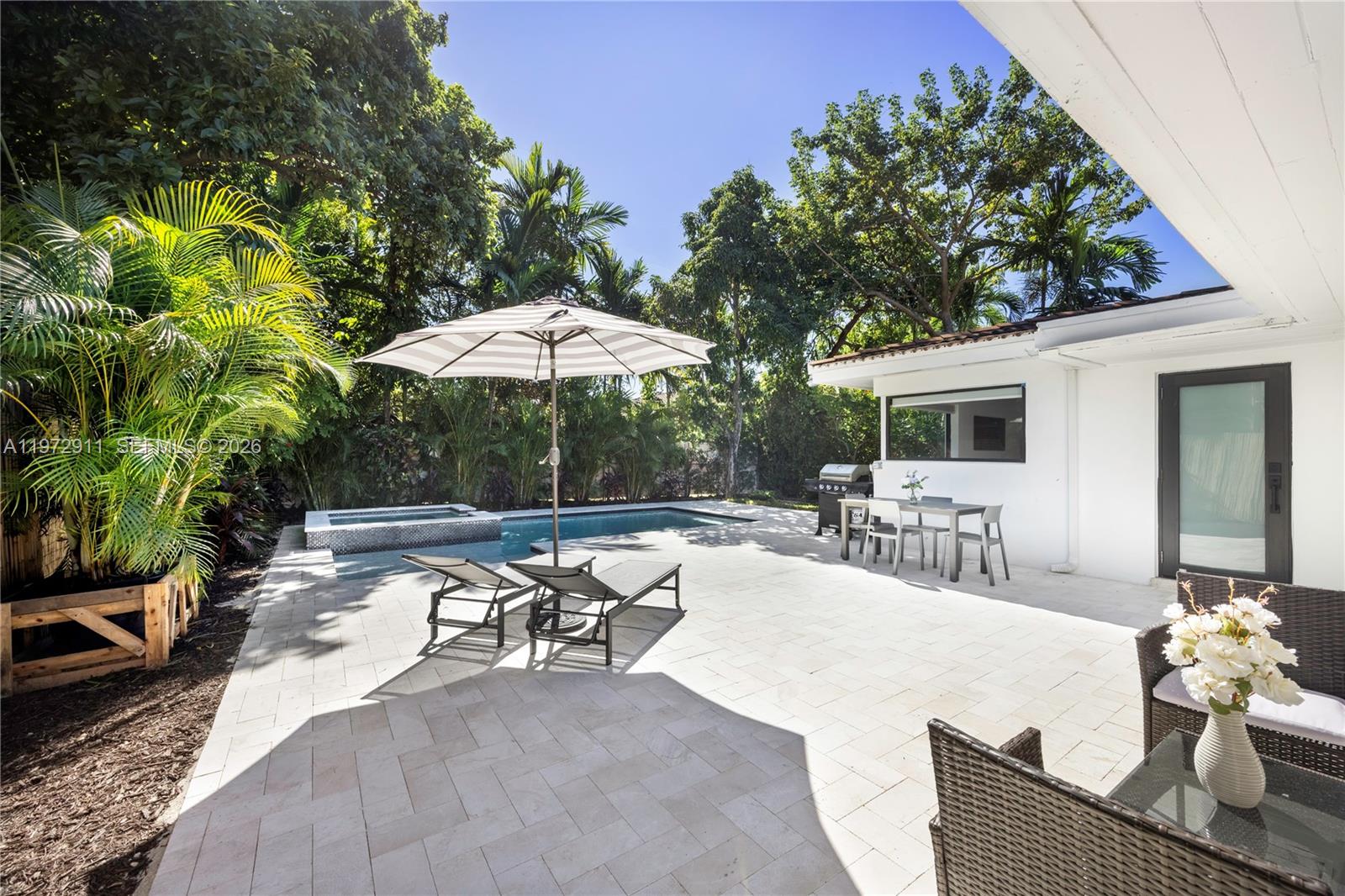 1860 Southwest 13th Street Miami, FL 33145 - Photo 2 of 21 a view of a patio with chairs and table under an umbrella