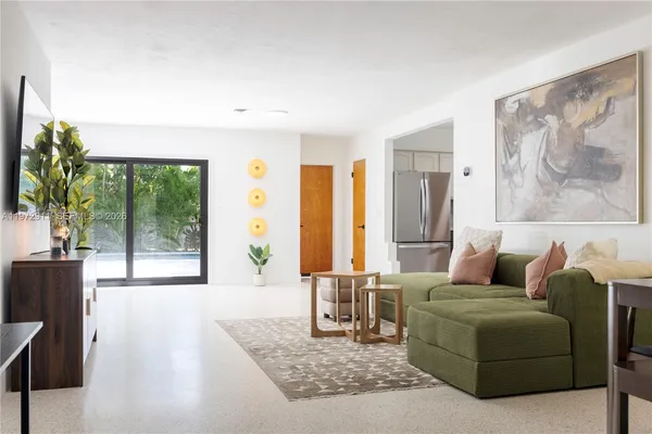 a living room with furniture and a large window