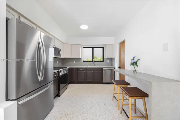 a kitchen with a refrigerator and a sink