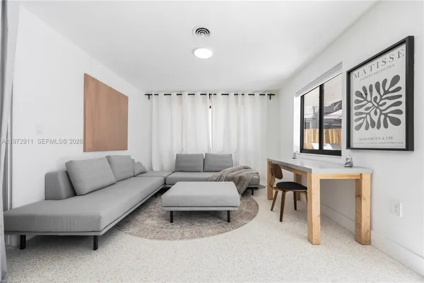 a living room with furniture and a large window