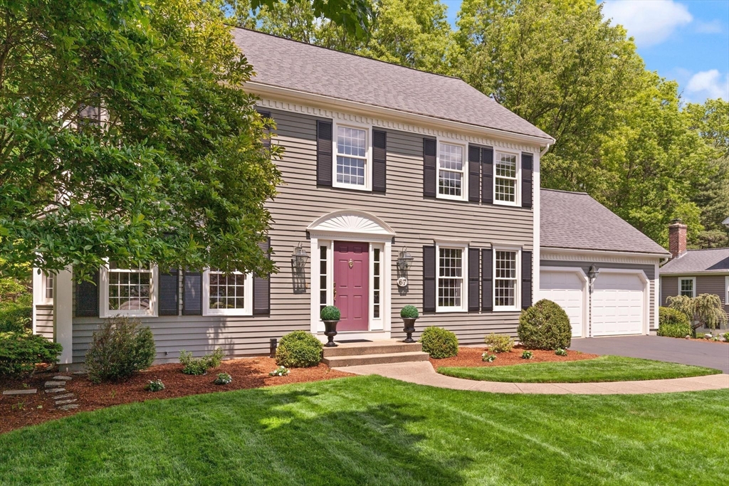 67 Bridle Path Franklin, MA 02038 - Photo 2 of 35 a front view of a house with a yard and garage