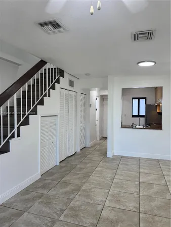 a view of entryway with stairs and a livingroom view