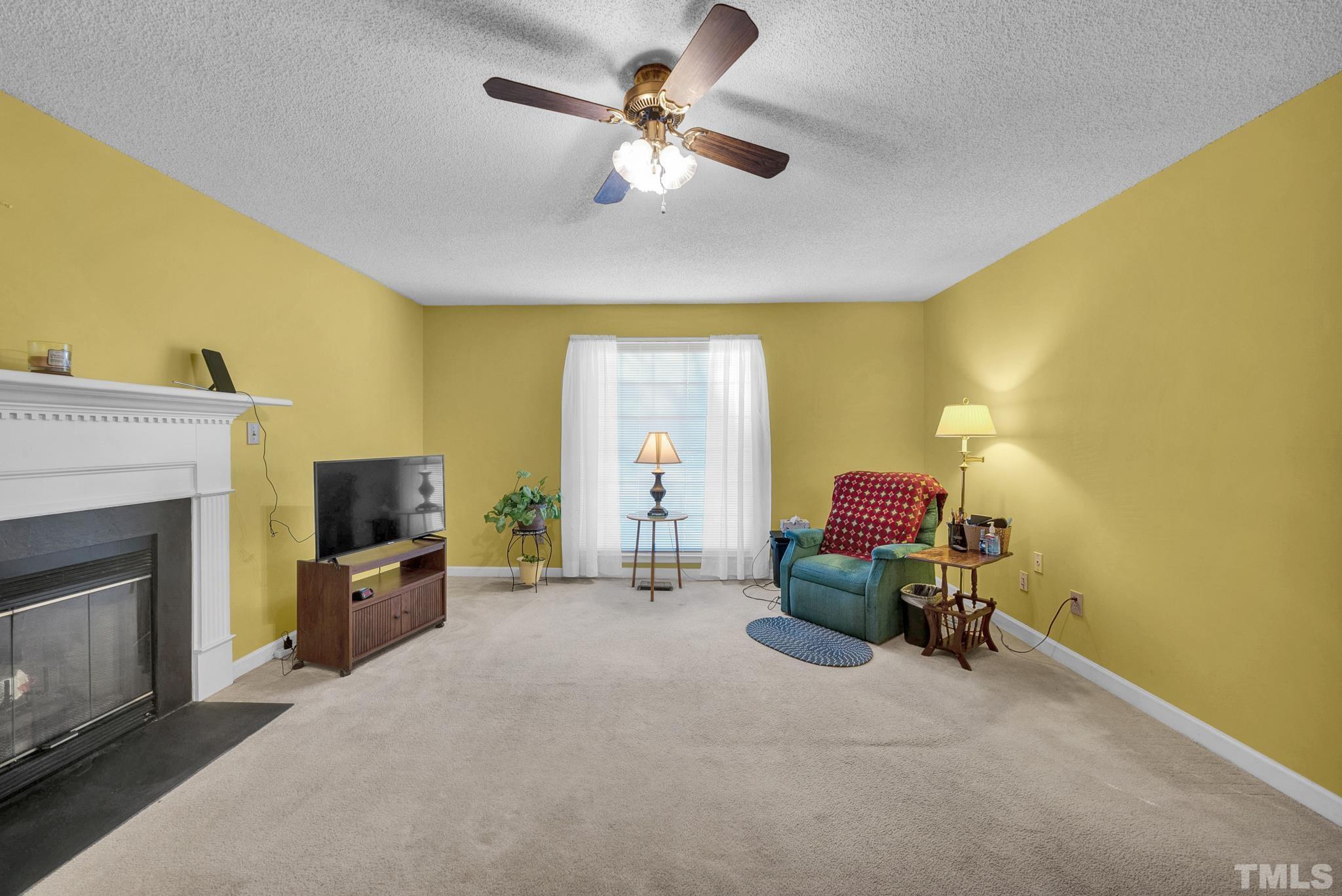 4201 Birmingham Way Raleigh, NC 27604 - Photo 22 of 38 a living room with furniture and a fireplace