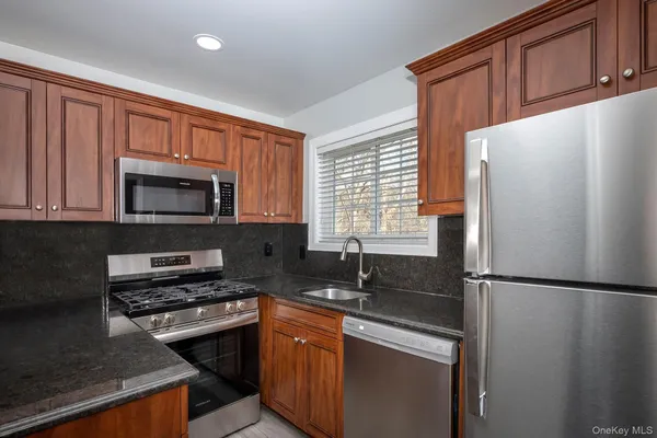 a kitchen with a refrigerator stove and microwave