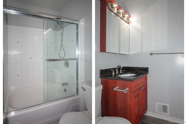 a bathroom with a granite countertop sink mirror vanity and toilet