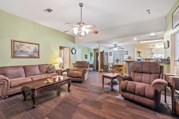 a living room with furniture a couch and a chandelier