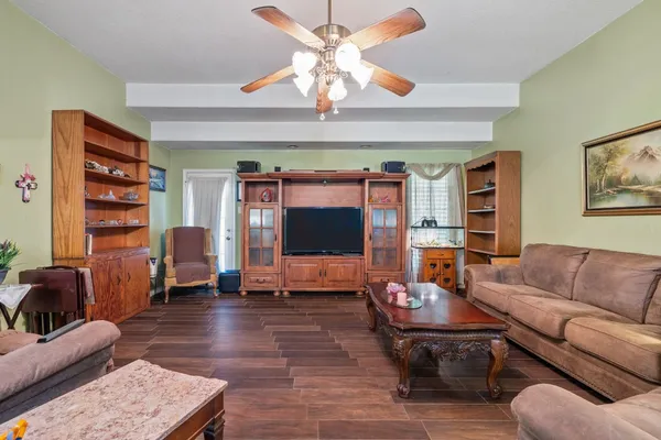 a living room with furniture and a flat screen tv