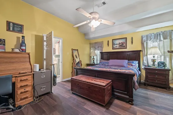 a bedroom with bed and wooden floor