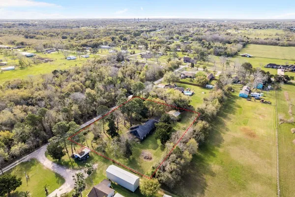 an aerial view of residential houses with outdoor space and lake view