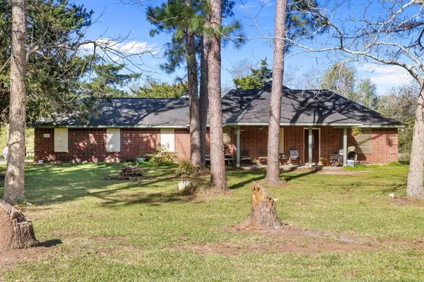 a view of a house with a yard and sitting area