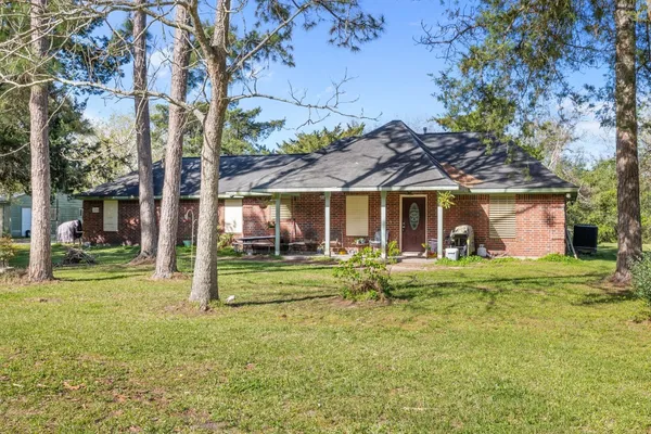 a front view of a house with a garden and porch