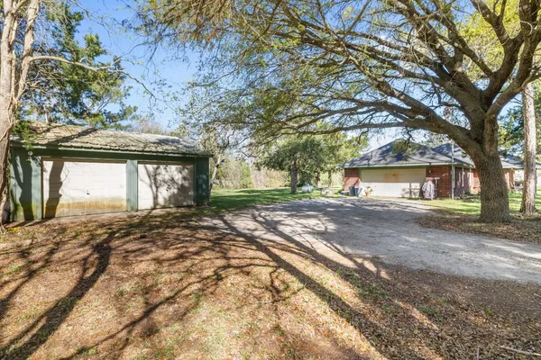 a view of a house with a yard and garage