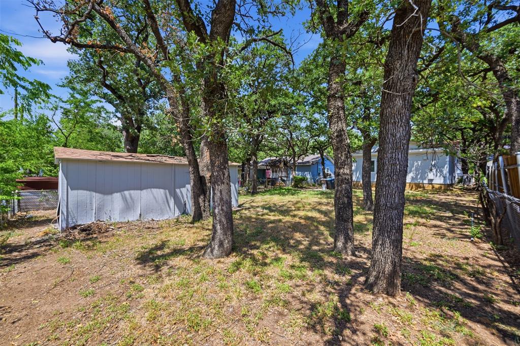 3308 Rufus Street Fort Worth, TX 76119 - Photo 15 of 17 Expansive natural landscape featuring multiple mature trees and partial fencing