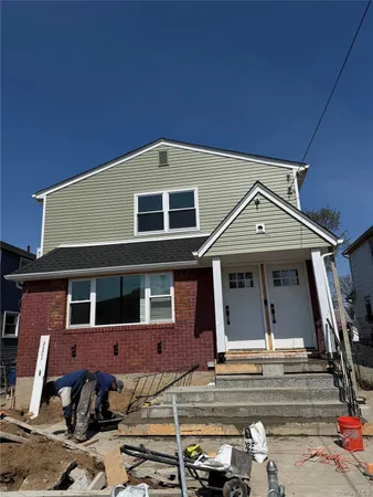 a front view of a house with parking space