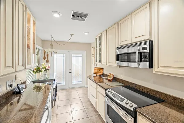 a kitchen with granite countertop a sink and a refrigerator