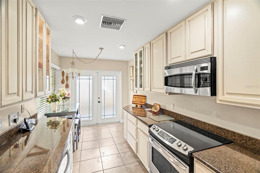 4730 Sheffield Drive New Port Richey, FL 34655 - Photo 11 of 53 a kitchen with stainless steel appliances granite countertop a stove and a microwave
