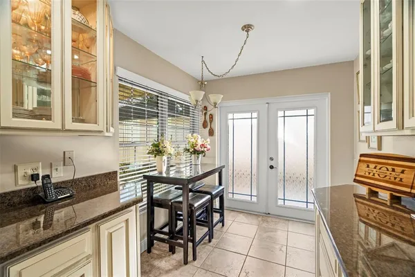 a large bathroom with a tub a sink and a large window