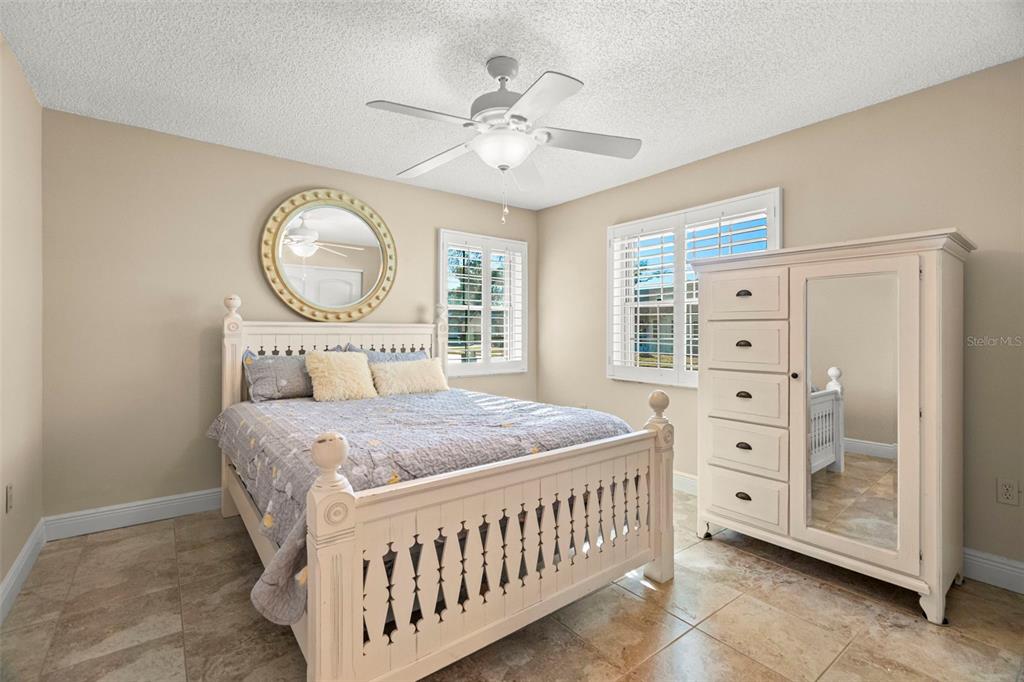 4730 Sheffield Drive New Port Richey, FL 34655 - Photo 16 of 53 a bedroom with furniture and a large window