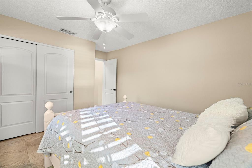4730 Sheffield Drive New Port Richey, FL 34655 - Photo 17 of 53 a bedroom with a bed and a chandelier