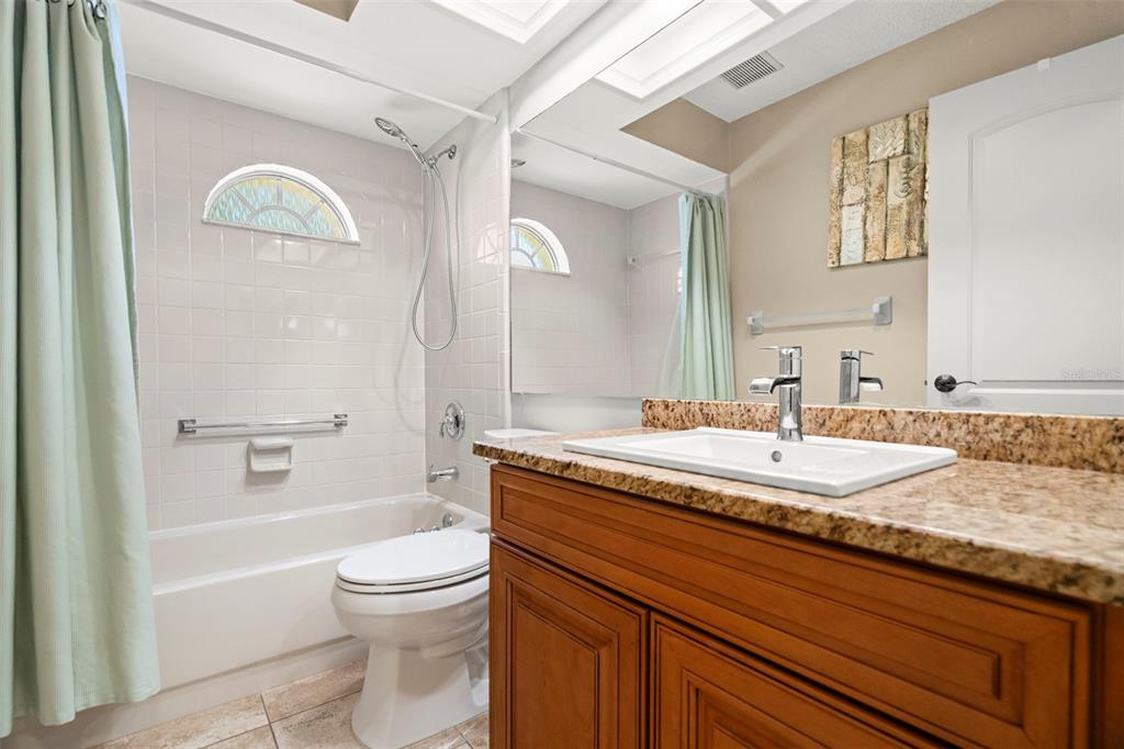 4730 Sheffield Drive New Port Richey, FL 34655 - Photo 19 of 53 a bathroom with a granite countertop toilet a sink and bathtub