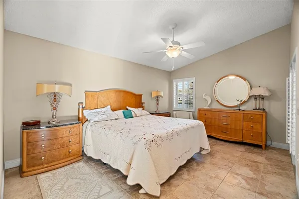 a bedroom with a large bed and a chandelier