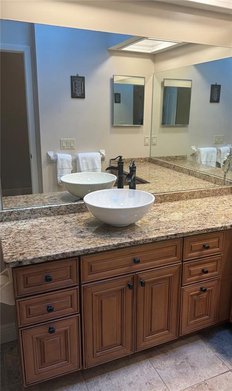 4730 Sheffield Drive New Port Richey, FL 34655 - Photo 23 of 53 a bathroom with a granite countertop double vanity sink and mirror