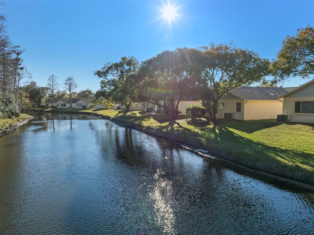 4730 Sheffield Drive New Port Richey, FL 34655 - Photo 37 of 53 a view of a lake from a yard