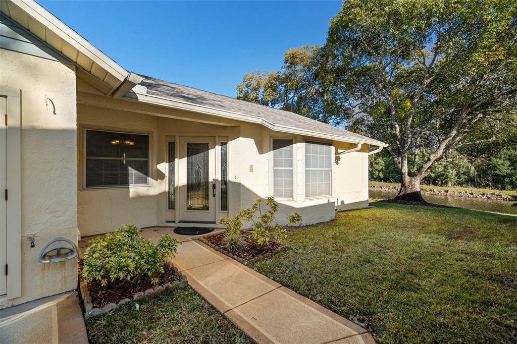 4730 Sheffield Drive New Port Richey, FL 34655 - Photo 4 of 53 a front view of a house with garden