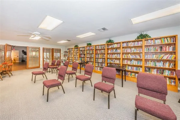 a living room with furniture a table and a large window