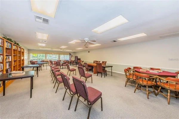 a view of a white house with a big yard