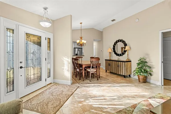a view of a hallway with a livingroom and dining room