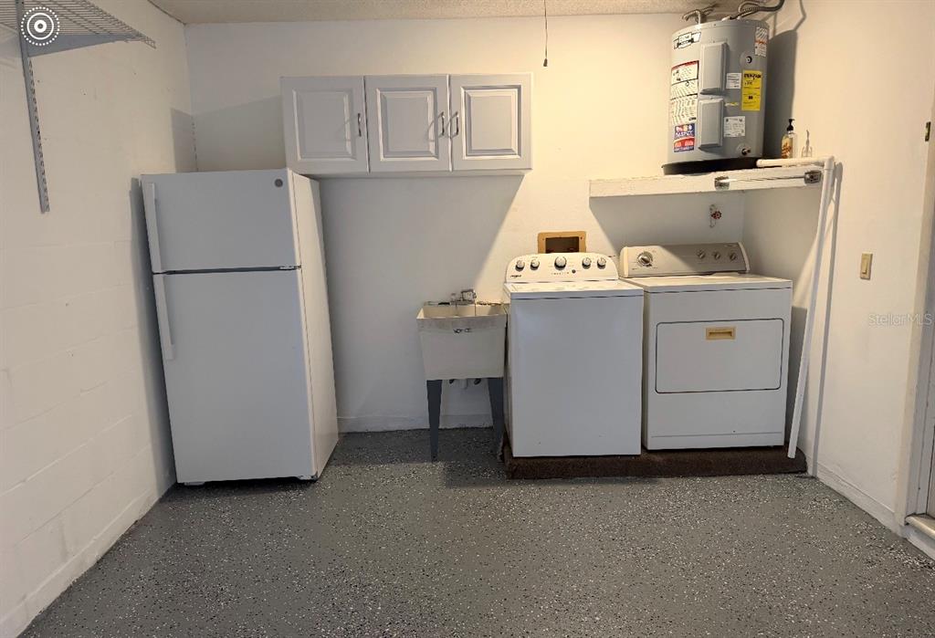 4730 Sheffield Drive New Port Richey, FL 34655 - Photo 52 of 53 a room with a refrigerator and cabinets