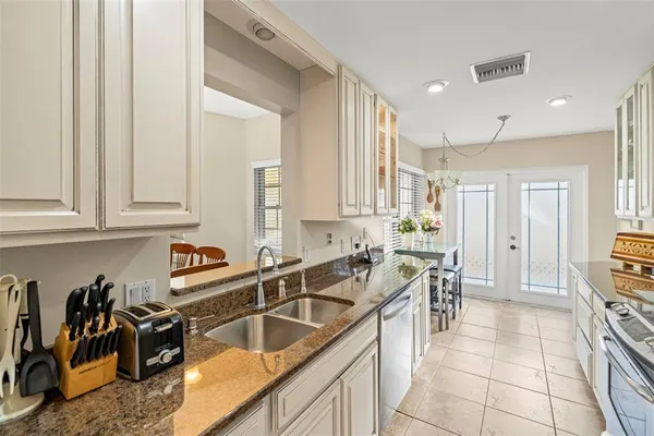 a kitchen with stainless steel appliances granite countertop a stove and a microwave