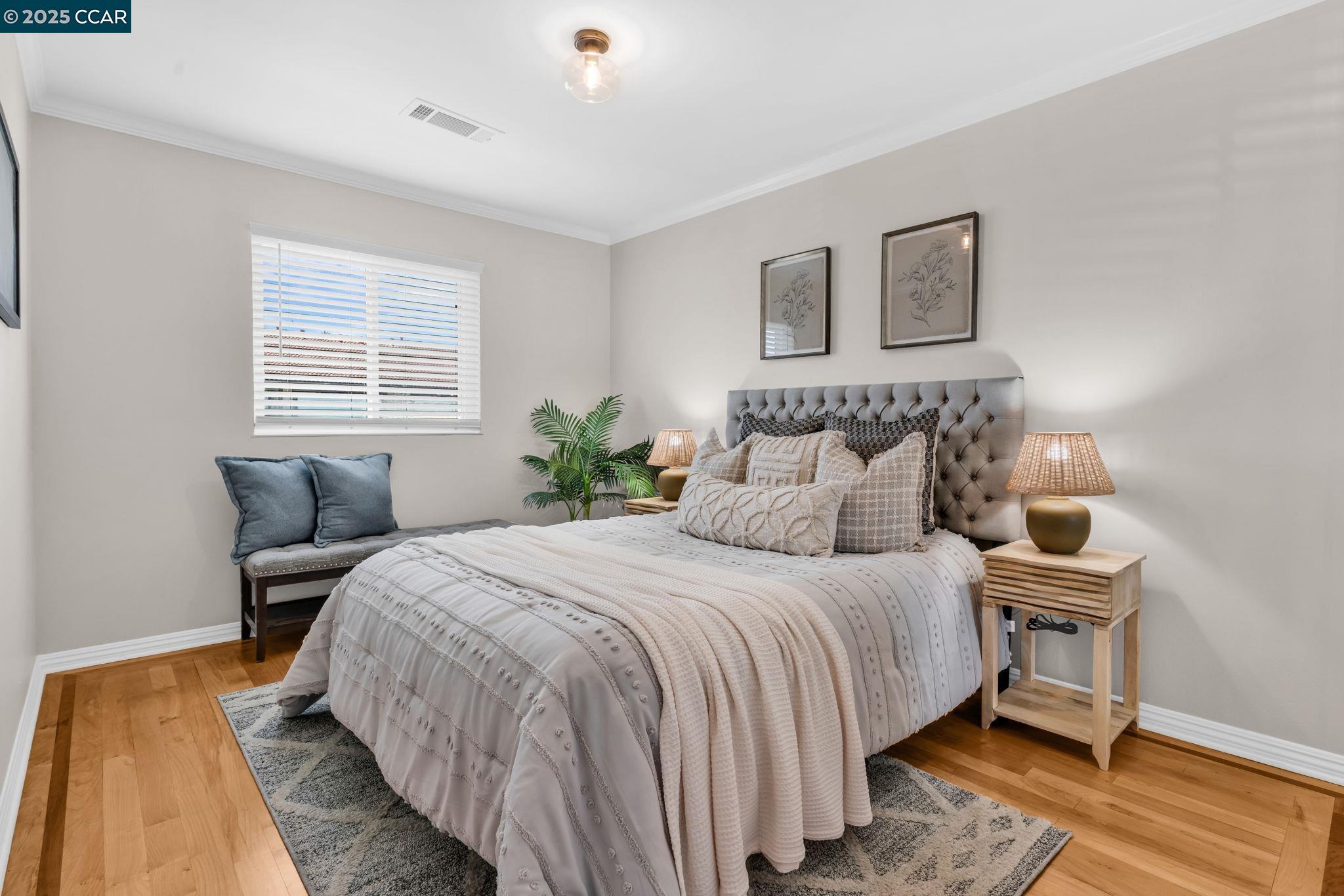 4380 St Charles Place Concord, CA 94521 - Photo 31 of 54 a bedroom with a bed and wooden floor