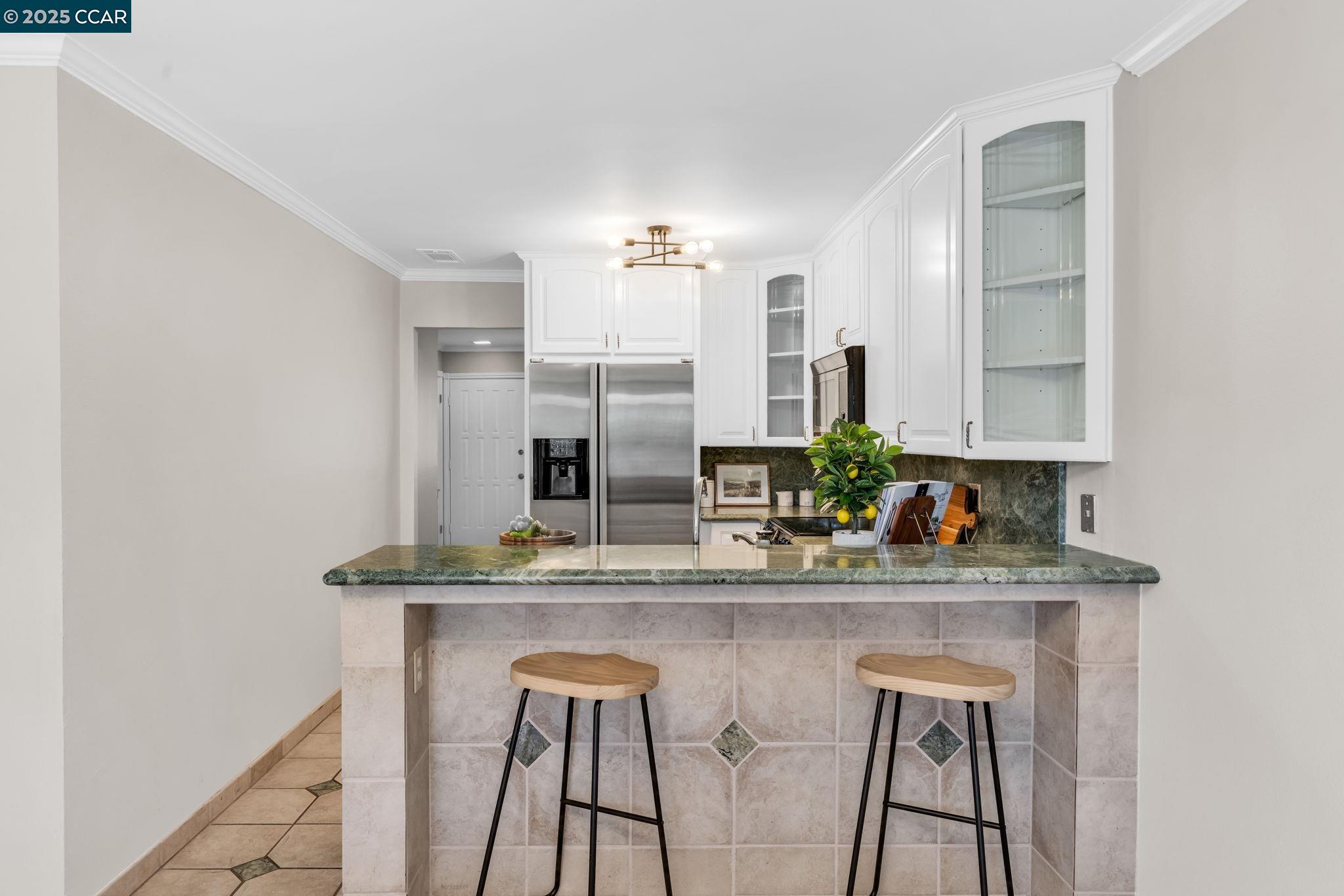 4380 St Charles Place Concord, CA 94521 - Photo 9 of 54 a kitchen with stainless steel appliances kitchen island a chandelier