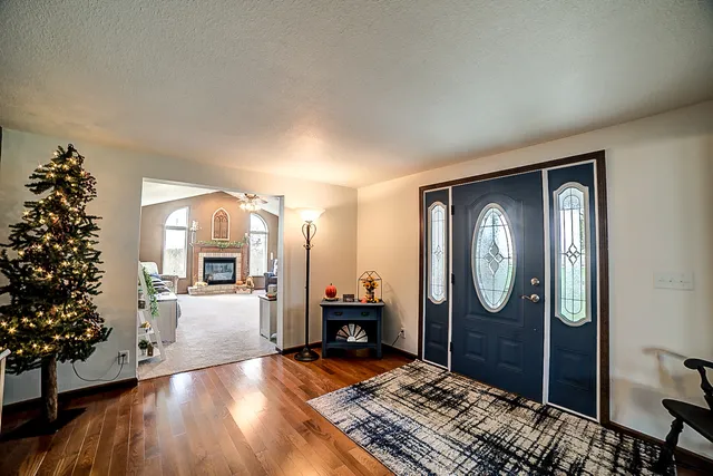 a view of a dining room with furniture and a chandelier