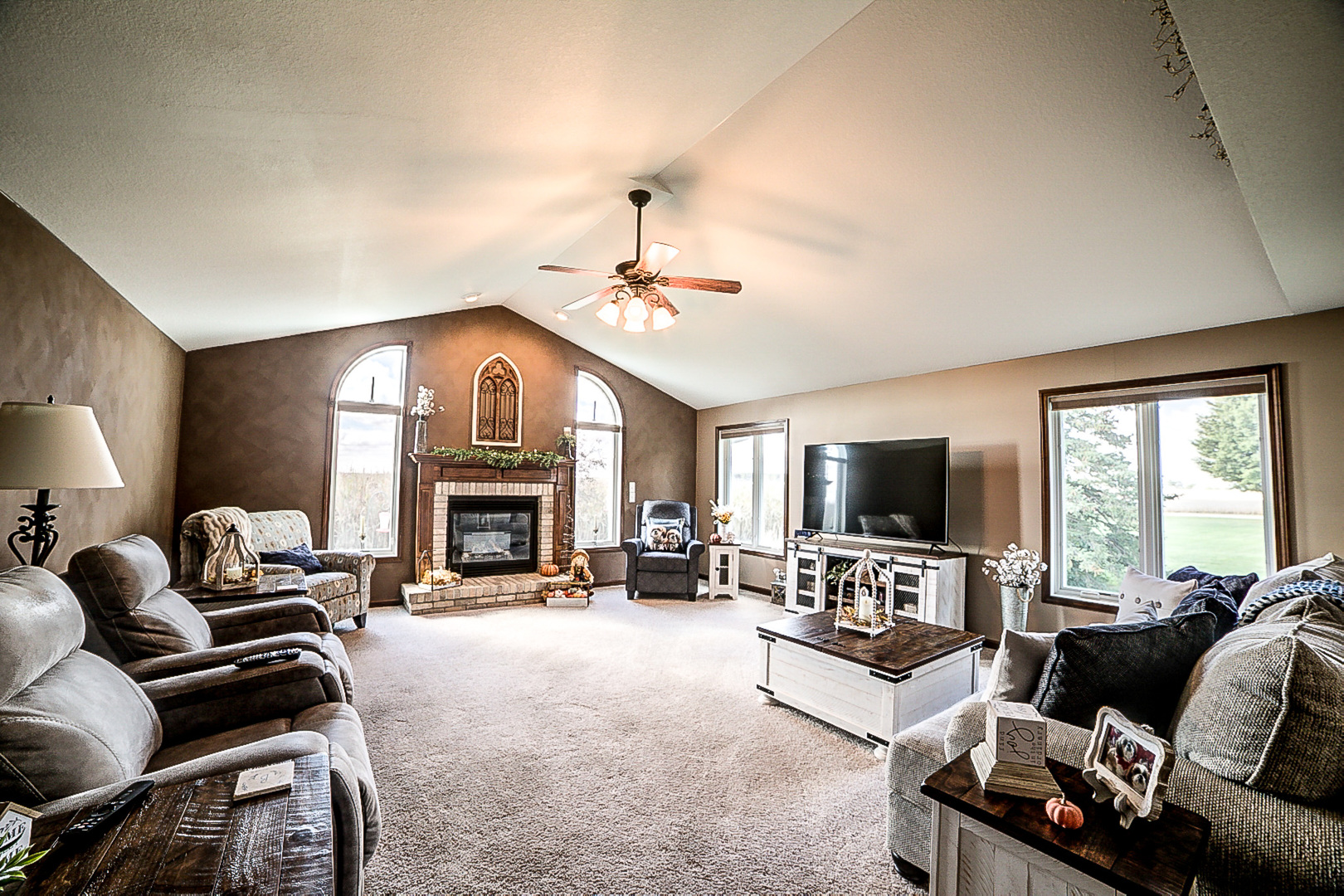 1718 North 1800 East Road Watseka, IL 60970 - Photo 23 of 113 a living room with furniture a fireplace and a flat screen tv