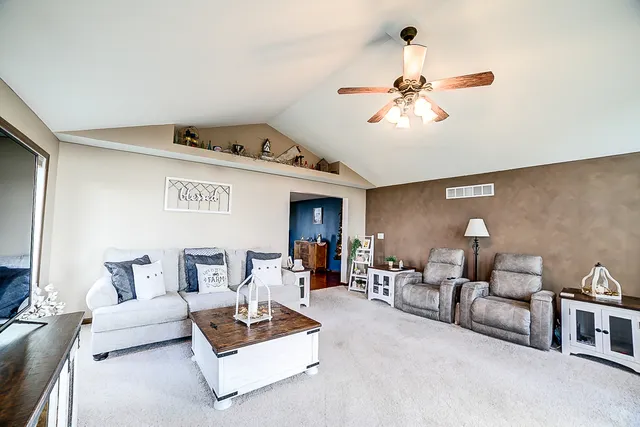 a view of a livingroom with furniture and a window