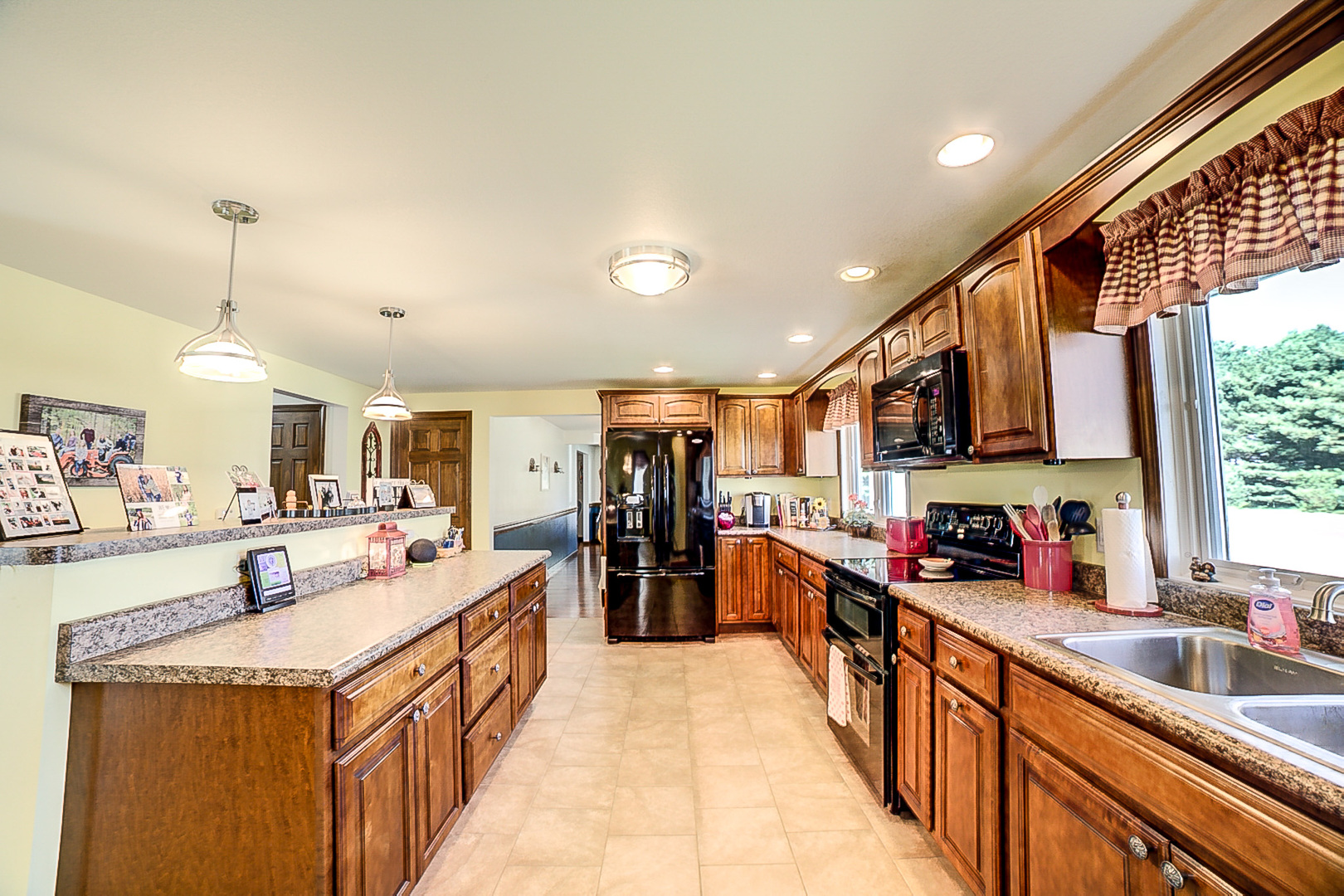 1718 North 1800 East Road Watseka, IL 60970 - Photo 37 of 113 a large kitchen with stainless steel appliances lots of counter space and a sink