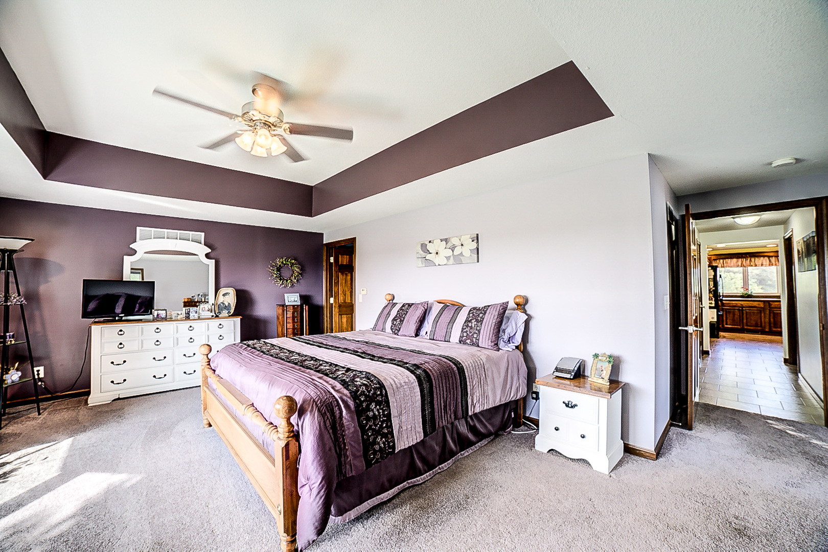 1718 North 1800 East Road Watseka, IL 60970 - Photo 48 of 113 a spacious bedroom with a bed and a chandelier