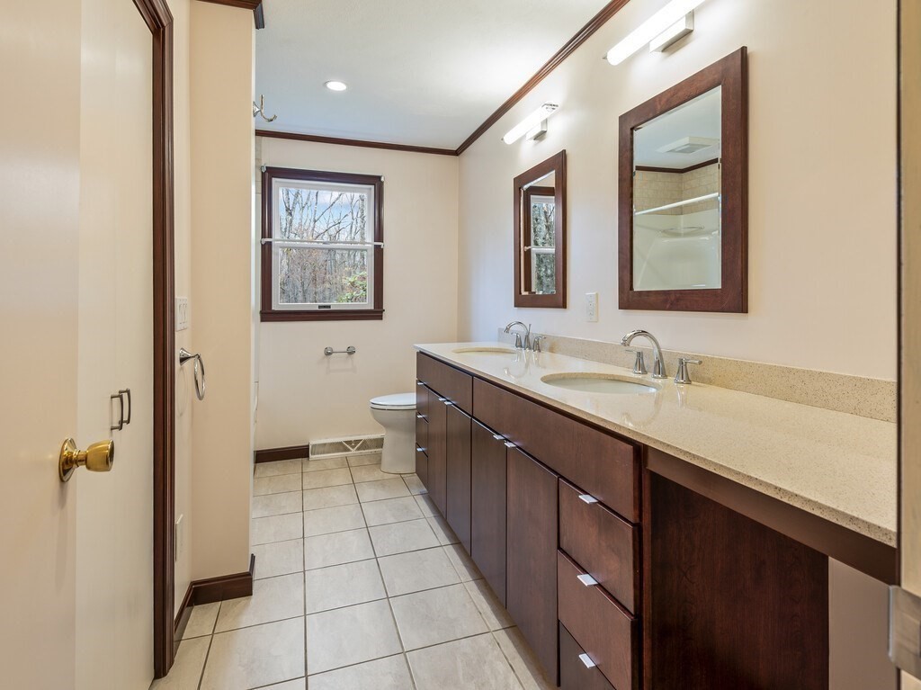 21 Hutchinson Road Sutton, MA 01590 - Photo 16 of 41 a spacious bathroom with a double vanity sink a mirror and a bathtub